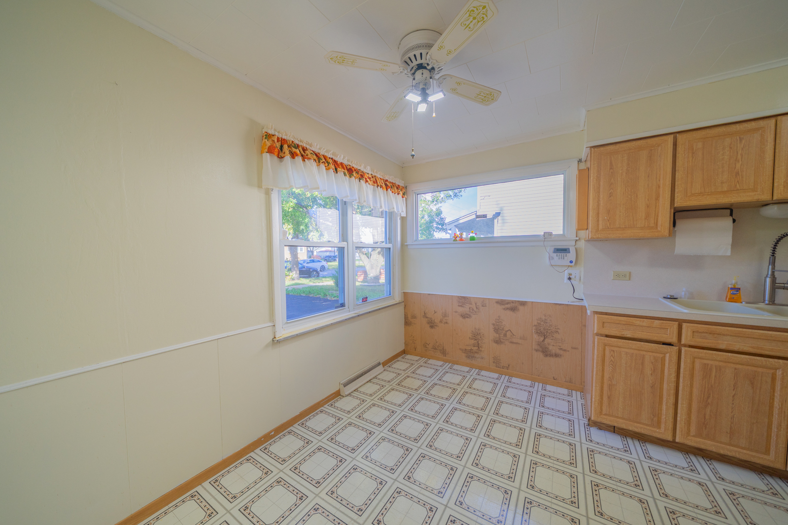 3437 Scott Street Franklin Park, IL 60131 - Photo 13 of 44 a kitchen with a sink a stove cabinets and a window