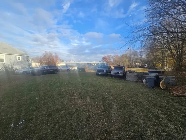 a view of a big yard with large trees