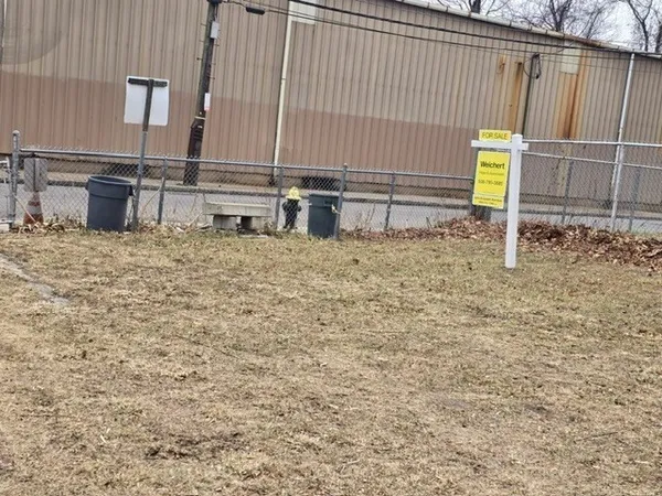 a view of wooden fence and a house