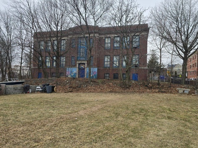 51 Ceylon Street Boston, MA 02121 - Photo 10 of 18 a view of a house with a yard covered in snow