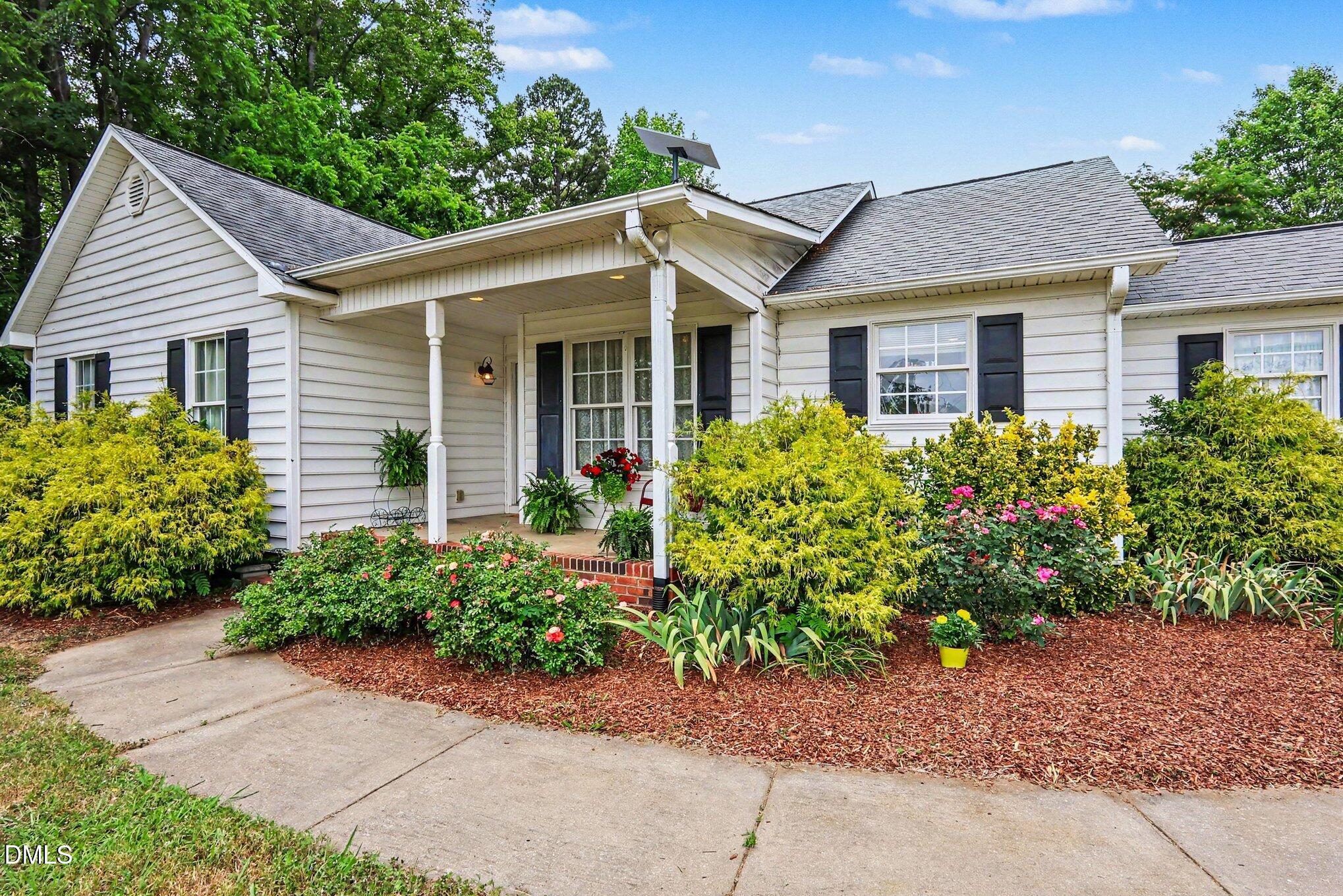 1750 Tom Oakley Road Timberlake, NC 27583 - Photo 4 of 31 a view of a house with a small yard and plants