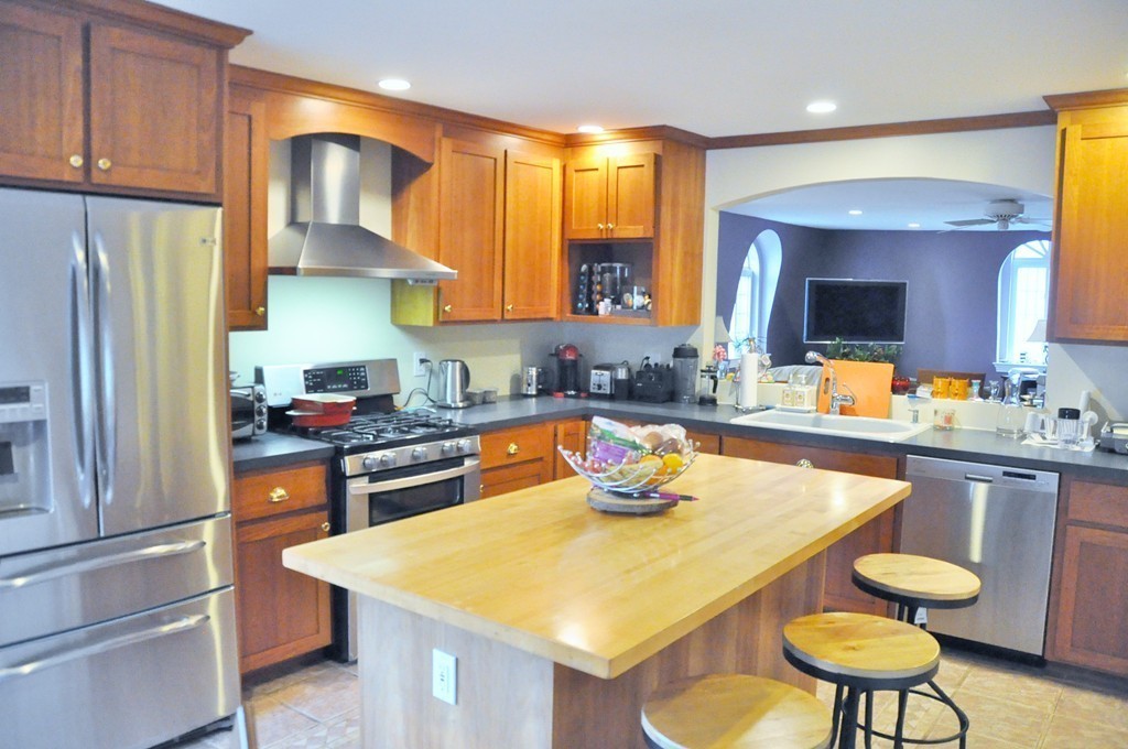 8-10 Bennington Street Newton, MA 02458 - Photo 11 of 22 a kitchen with a sink a stove and chairs