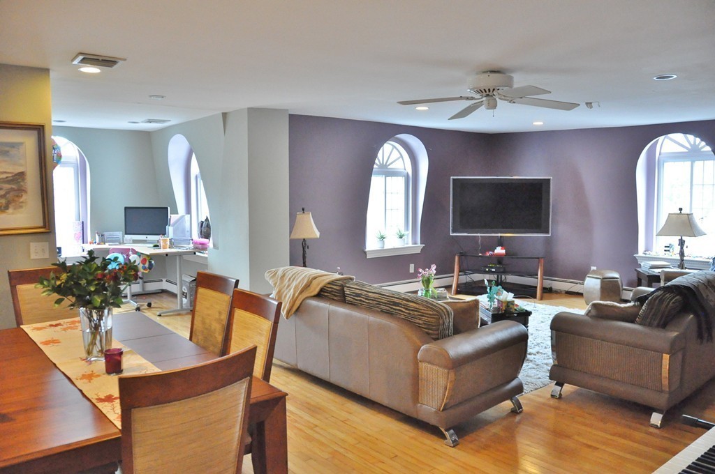 8-10 Bennington Street Newton, MA 02458 - Photo 12 of 22 a living room with furniture and a large mirror