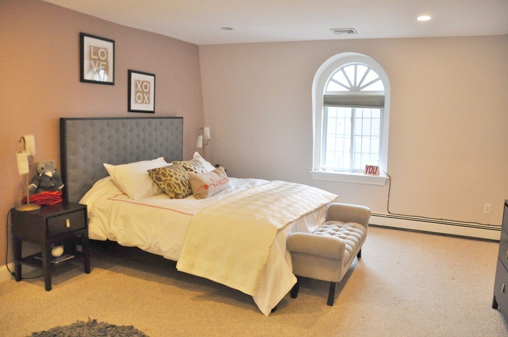 8-10 Bennington Street Newton, MA 02458 - Photo 14 of 22 a bedroom with a bed and a chair