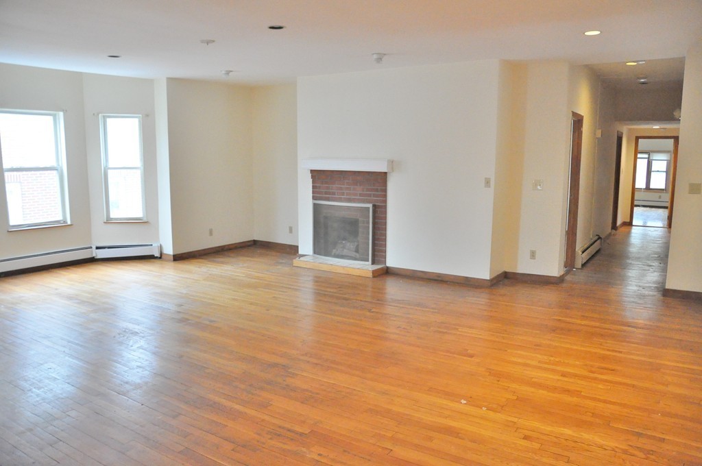8-10 Bennington Street Newton, MA 02458 - Photo 17 of 22 an empty room with wooden floor and windows