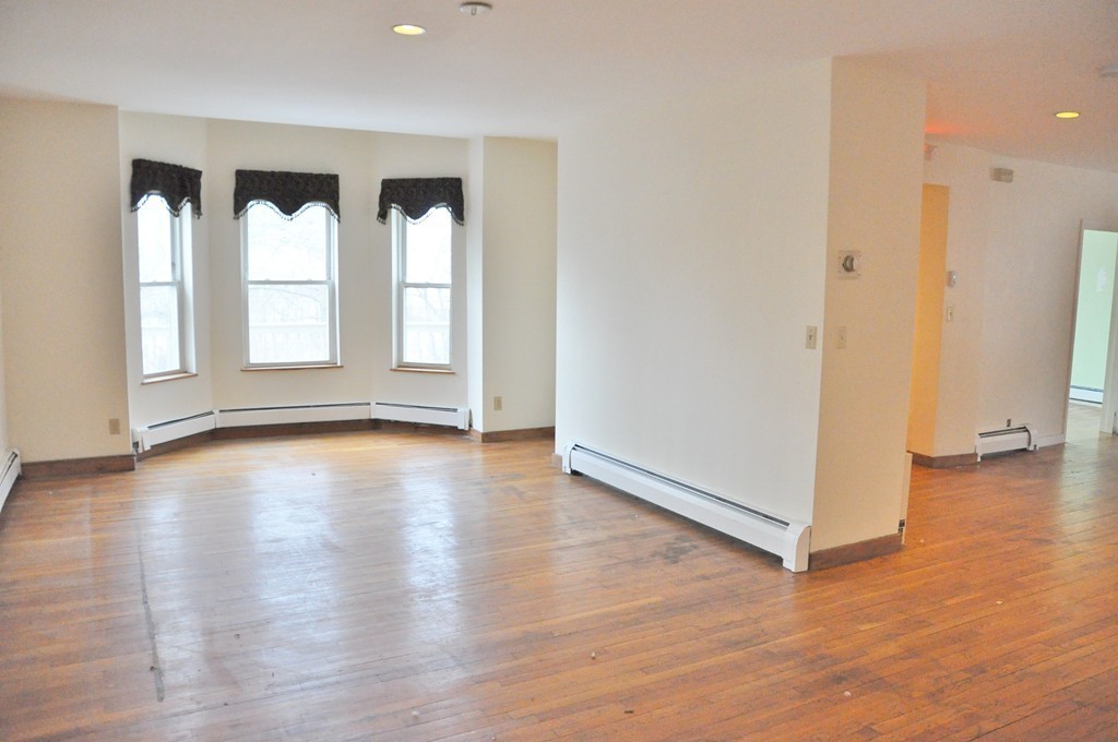 8-10 Bennington Street Newton, MA 02458 - Photo 18 of 22 an empty room with wooden floor and windows