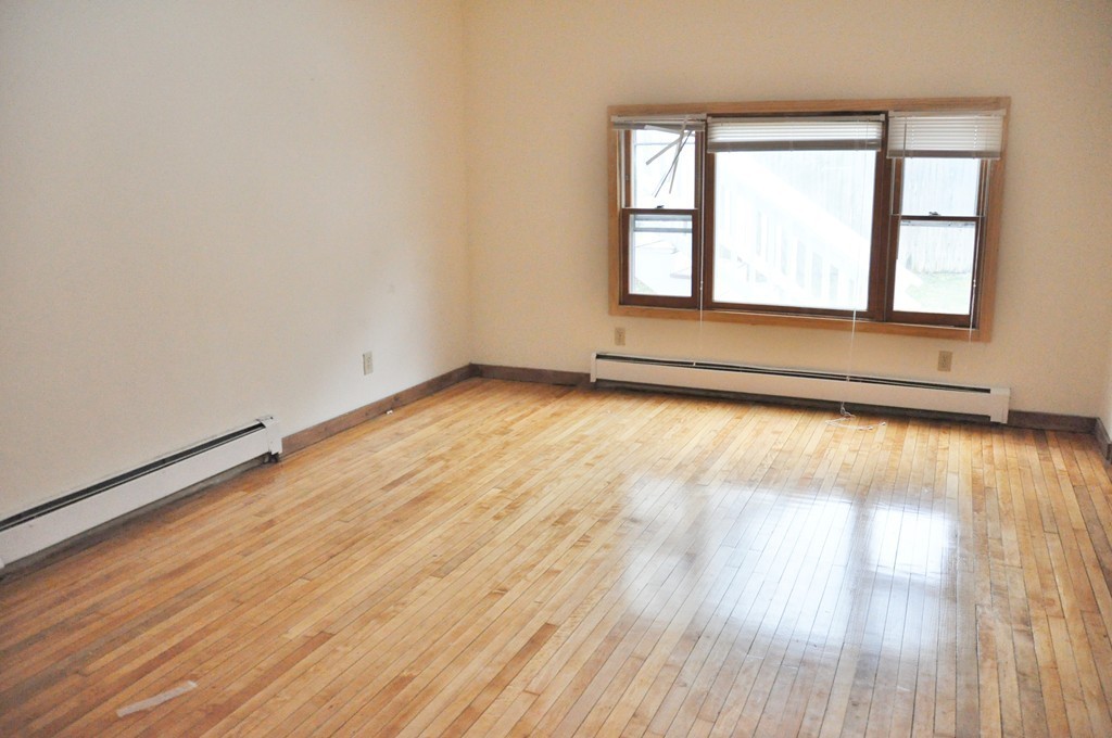 8-10 Bennington Street Newton, MA 02458 - Photo 21 of 22 an empty room with wooden floor and windows