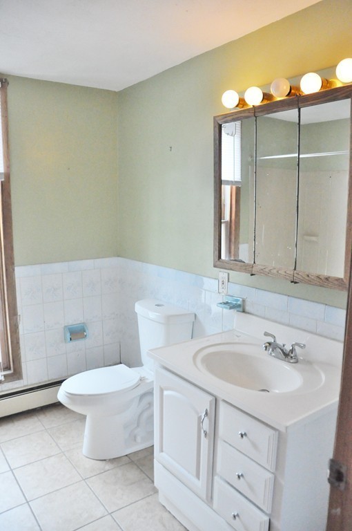 8-10 Bennington Street Newton, MA 02458 - Photo 22 of 22 a bathroom with a sink a toilet and mirror