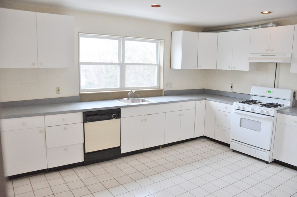 8-10 Bennington Street Newton, MA 02458 - Photo 7 of 22 a white kitchen with a sink and cabinets