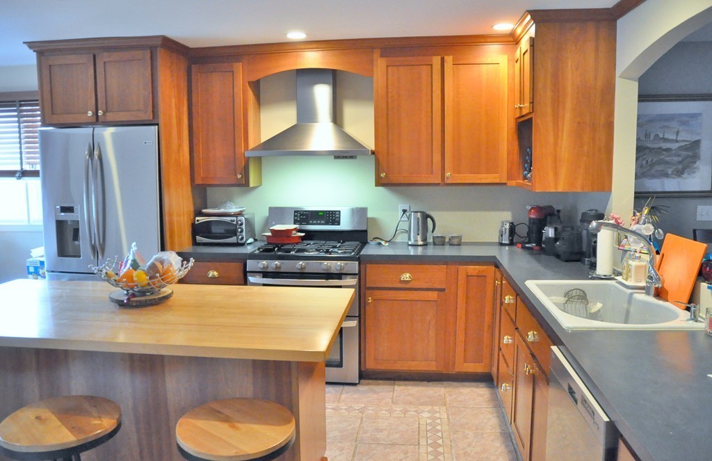 8-10 Bennington Street Newton, MA 02458 - Photo 10 of 22 a kitchen with stainless steel appliances a sink a stove and a refrigerator