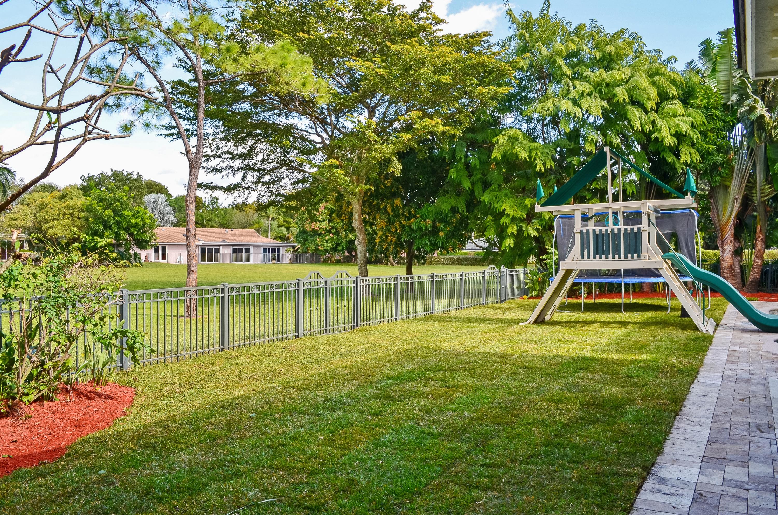 2121 Northwest 30th Road Boca Raton, FL 33431 - Photo 18 of 37 Backyard and swingset