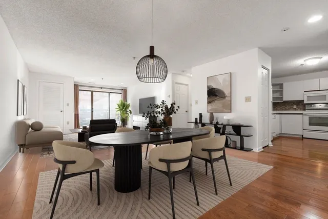 a view of a dining room with furniture window and wooden floor