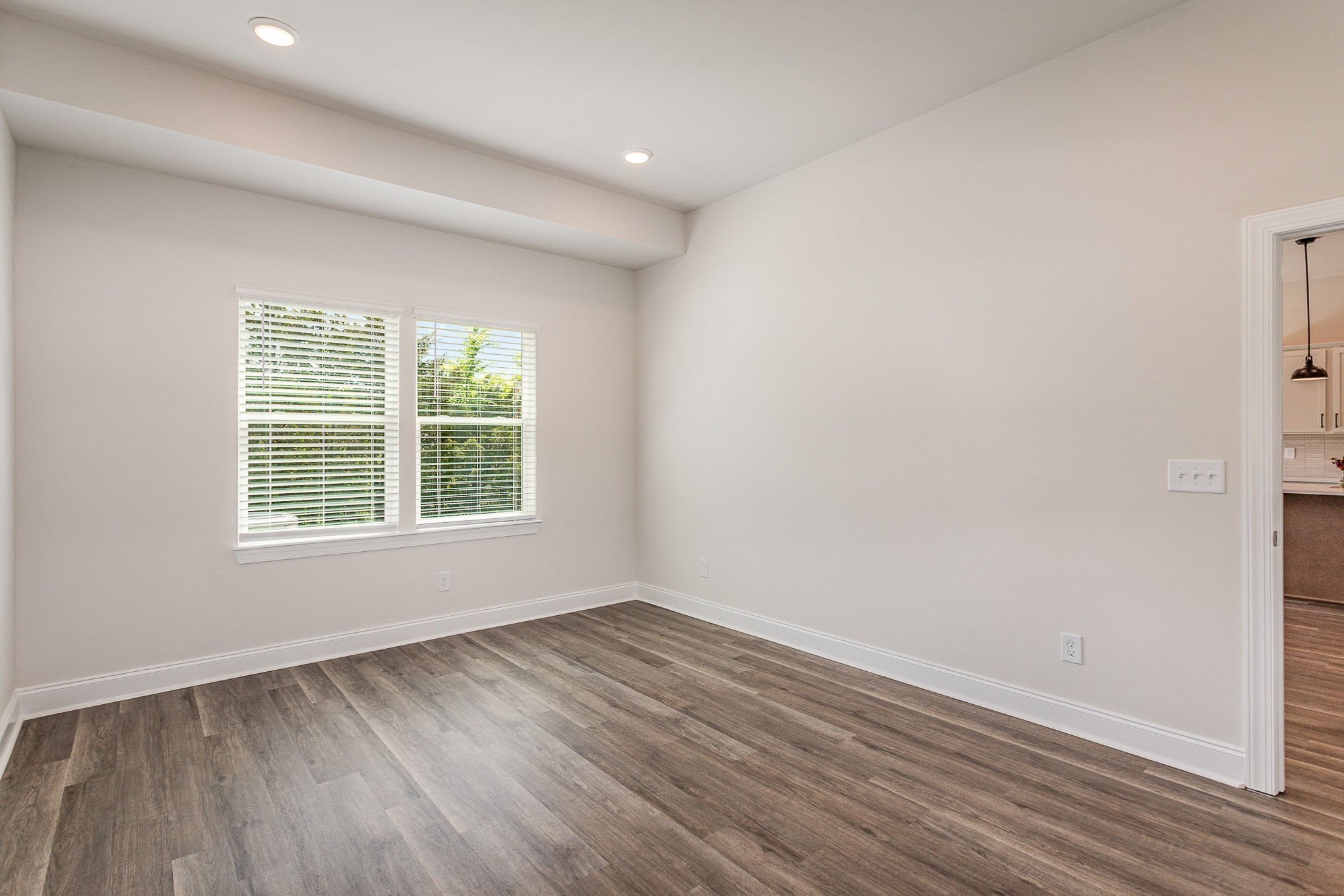 6423 Waymeet Dr Spring Hill Spring Hill, TN 37174 - Photo 4 of 19 an empty room with wooden floor and windows
