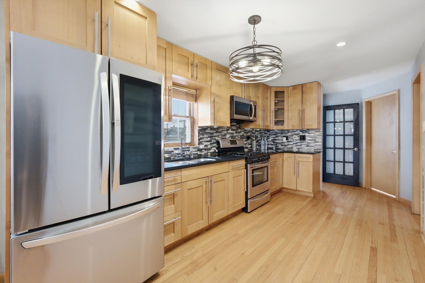 3701 West 80th Street Chicago, IL 60652 - Photo 11 of 34 a large kitchen with stainless steel appliances granite countertop a stove and a refrigerator