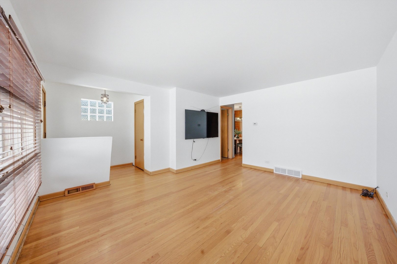 3701 West 80th Street Chicago, IL 60652 - Photo 5 of 34 a view of an empty room with wooden floor and a window