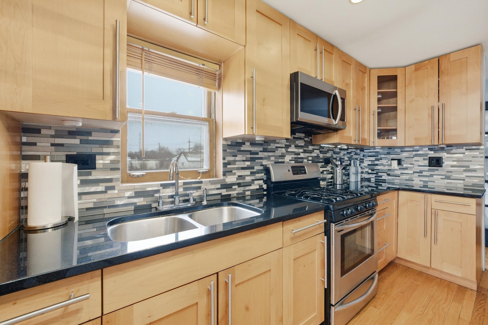 3701 West 80th Street Chicago, IL 60652 - Photo 10 of 34 a kitchen with granite countertop a sink and a stove top oven