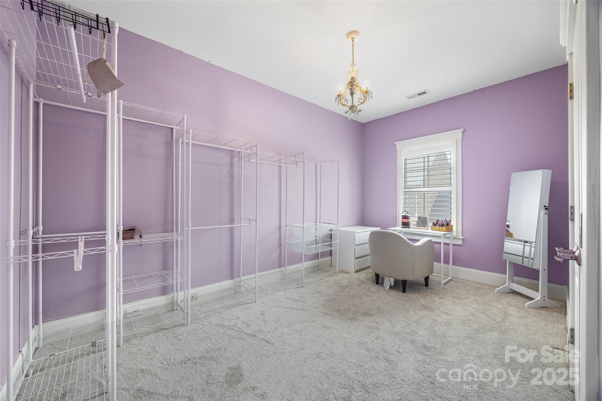 321 Landers Way Belmont, NC 28012 - Photo 18 of 26 a spacious bedroom with a bed and a chandelier