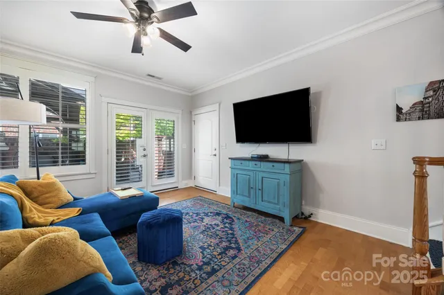 a living room with furniture a rug and white walls