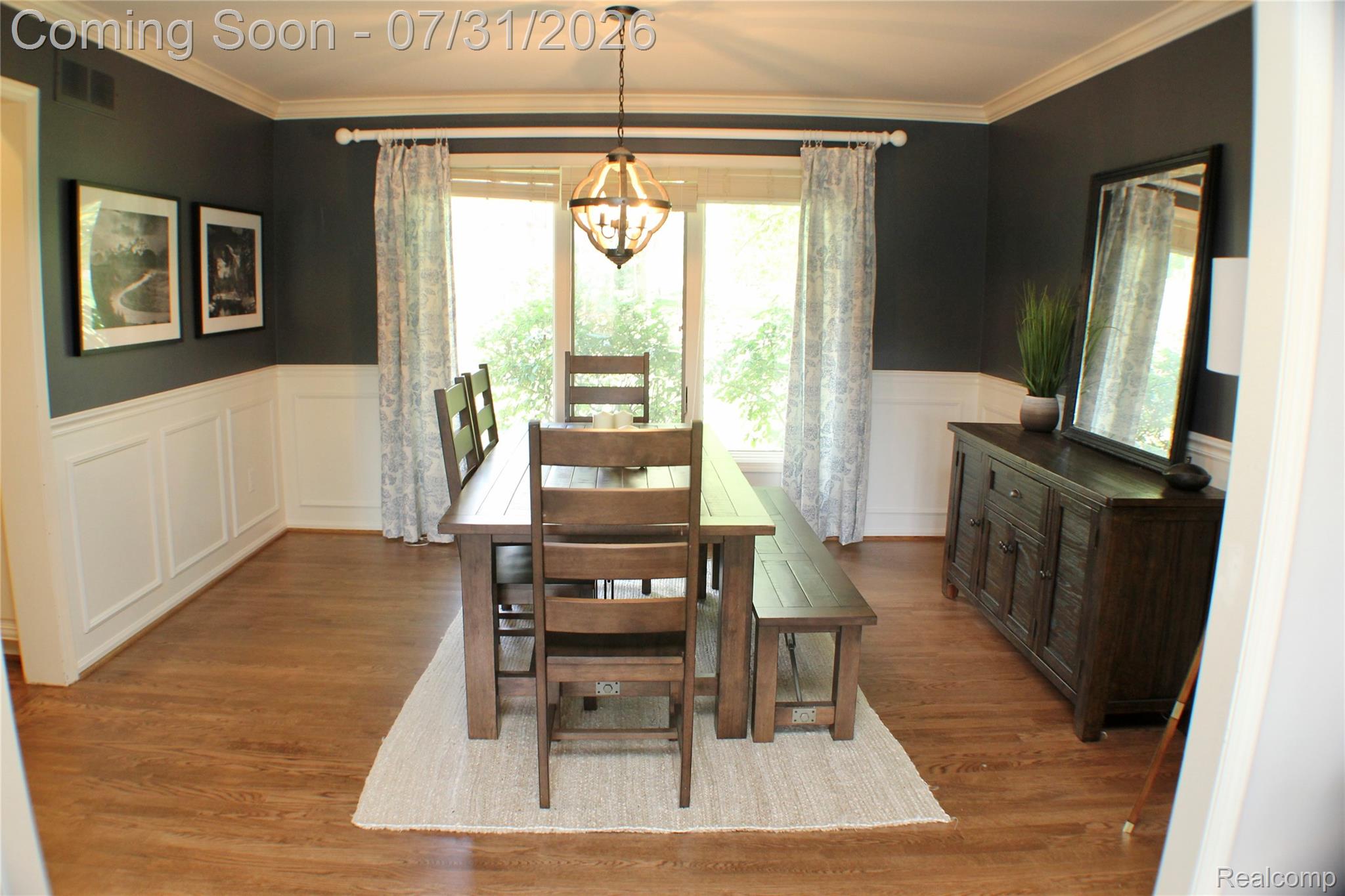 362 Lake Forest Road Rochester, MI 48309 - Photo 11 of 50 Dining area featuring wood-finish flooring, wainscoting, crown molding, and a chandelier
