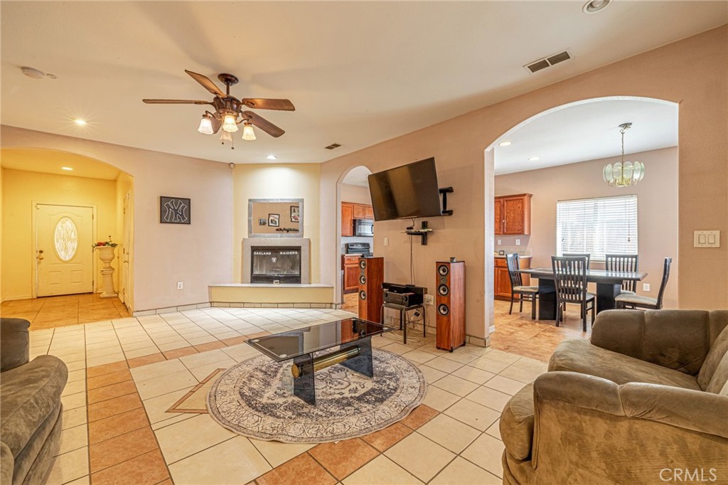 21419-21419 Neuralia Road California City, CA 93505 - Photo 11 of 35 a living room with furniture and a flat screen tv