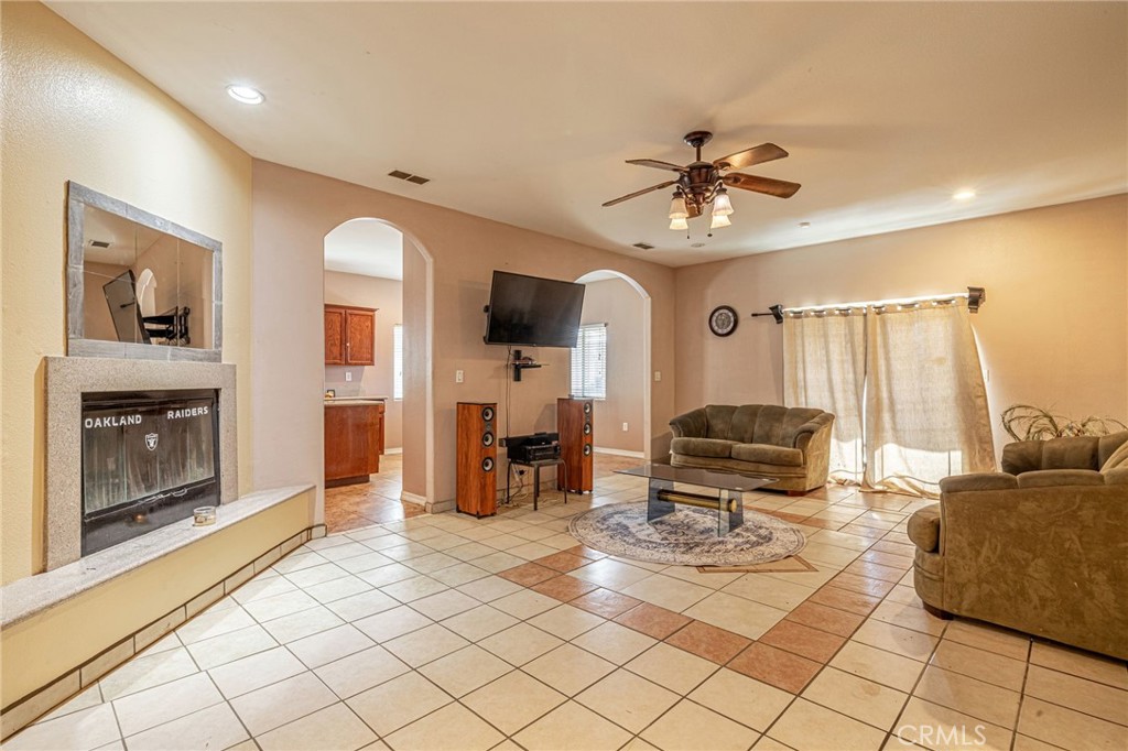 21419-21419 Neuralia Road California City, CA 93505 - Photo 9 of 35 a living room with furniture and a fireplace