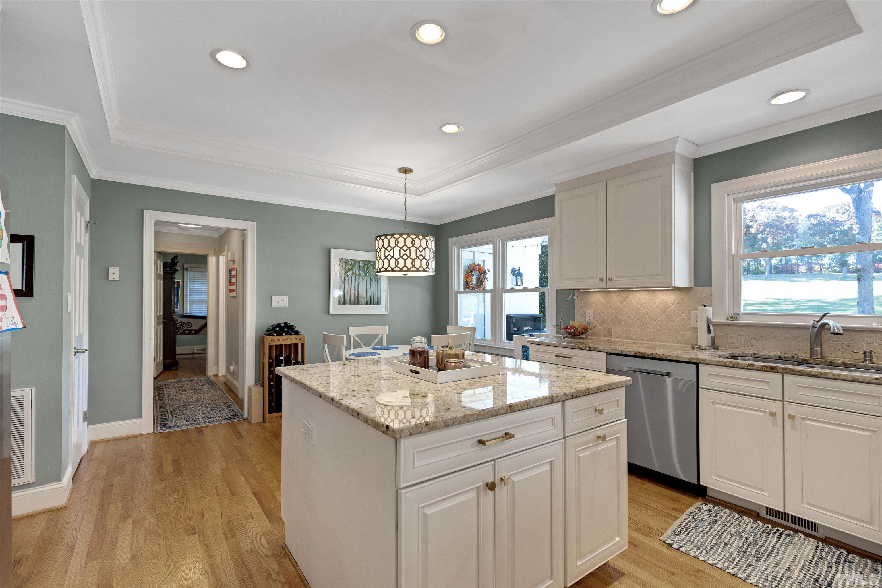 6813 Foxfire Place Raleigh, NC 27615 - Photo 12 of 38 a kitchen with a sink stove and cabinets