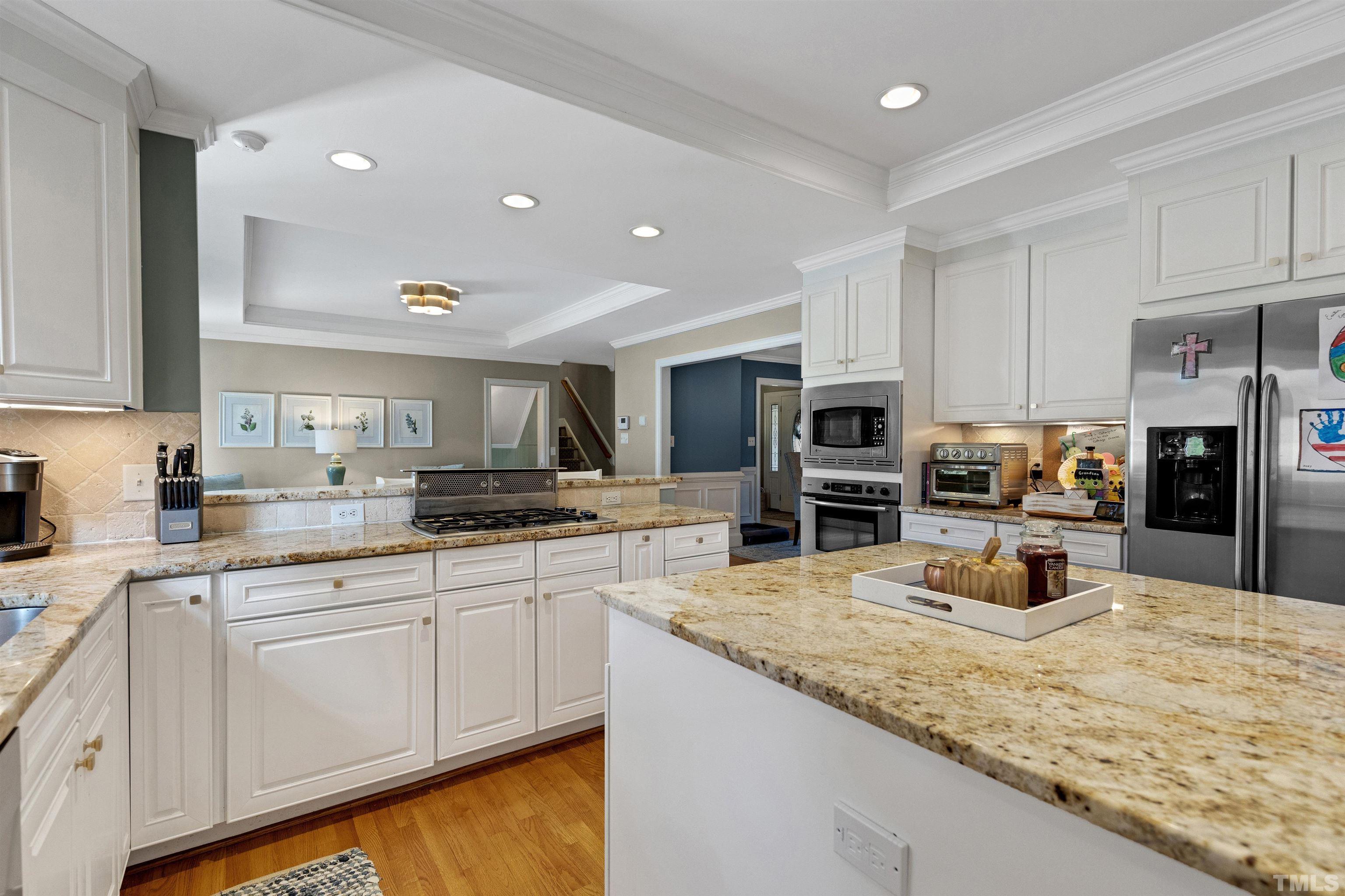 6813 Foxfire Place Raleigh, NC 27615 - Photo 14 of 38 a kitchen with stainless steel appliances granite countertop a sink and cabinets