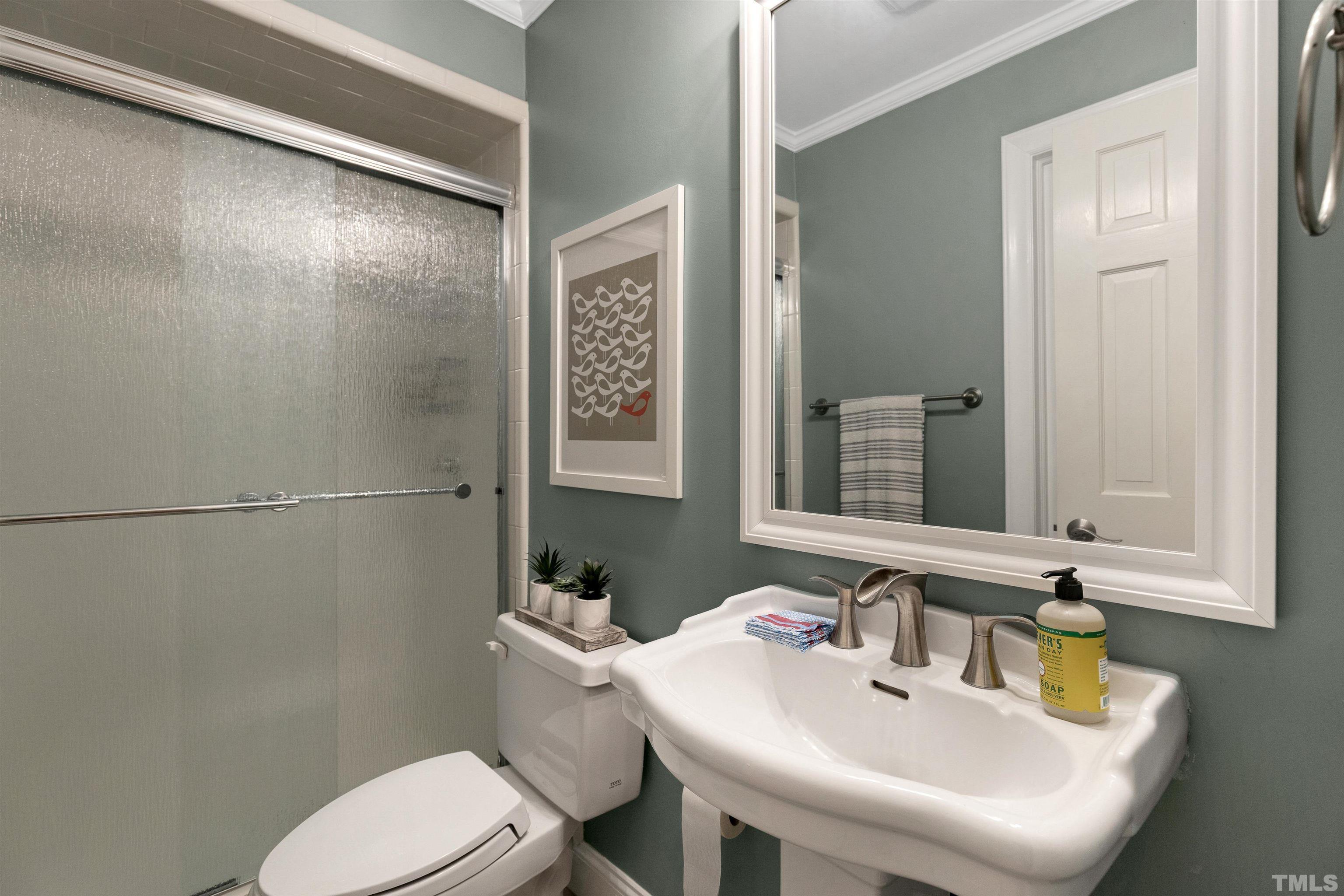 6813 Foxfire Place Raleigh, NC 27615 - Photo 16 of 38 a bathroom with a sink a toilet and shower