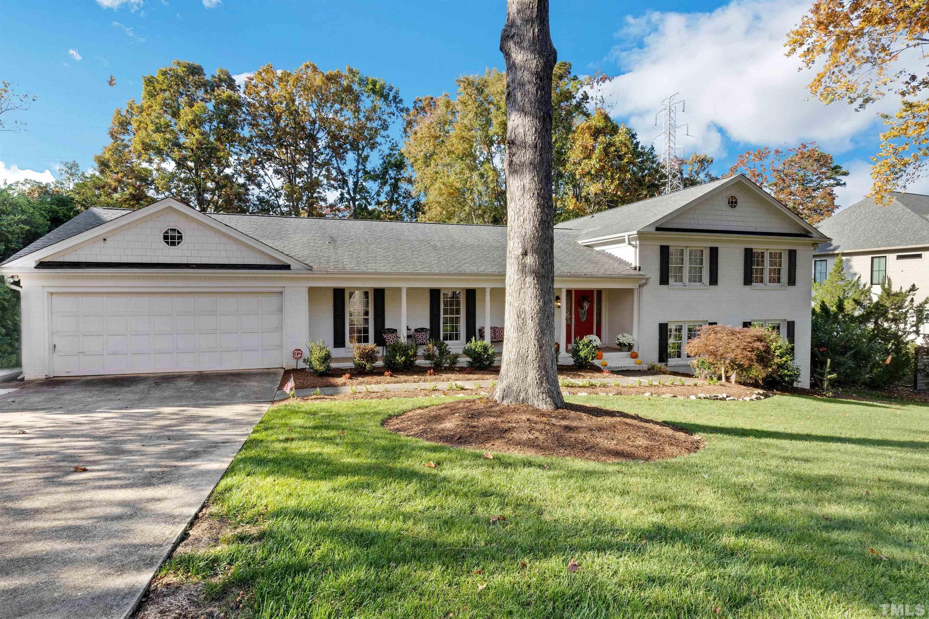 6813 Foxfire Place Raleigh, NC 27615 - Photo 2 of 38 a front view of a house with a garden and yard