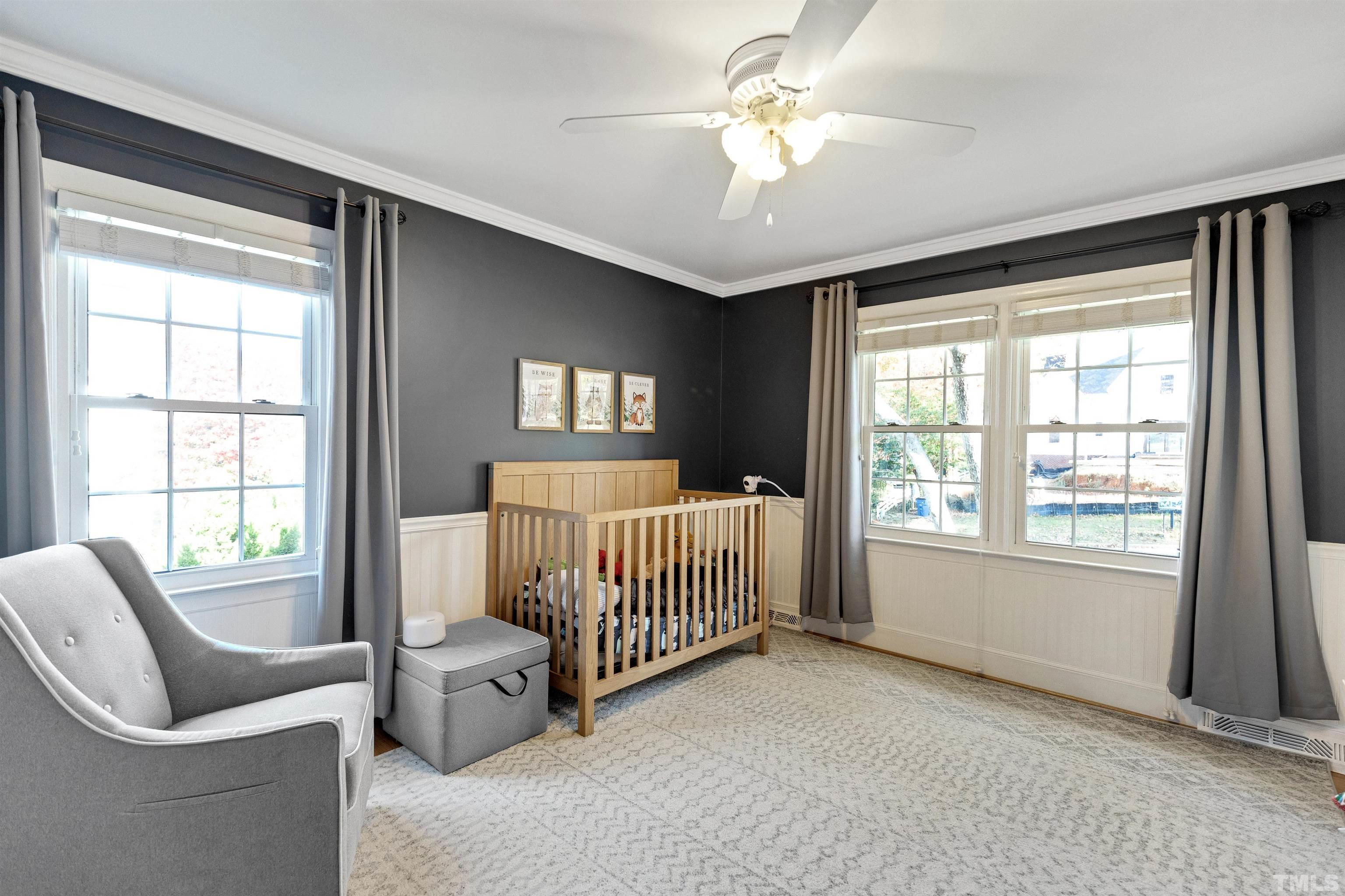 6813 Foxfire Place Raleigh, NC 27615 - Photo 21 of 38 a bedroom with a bed and glass window
