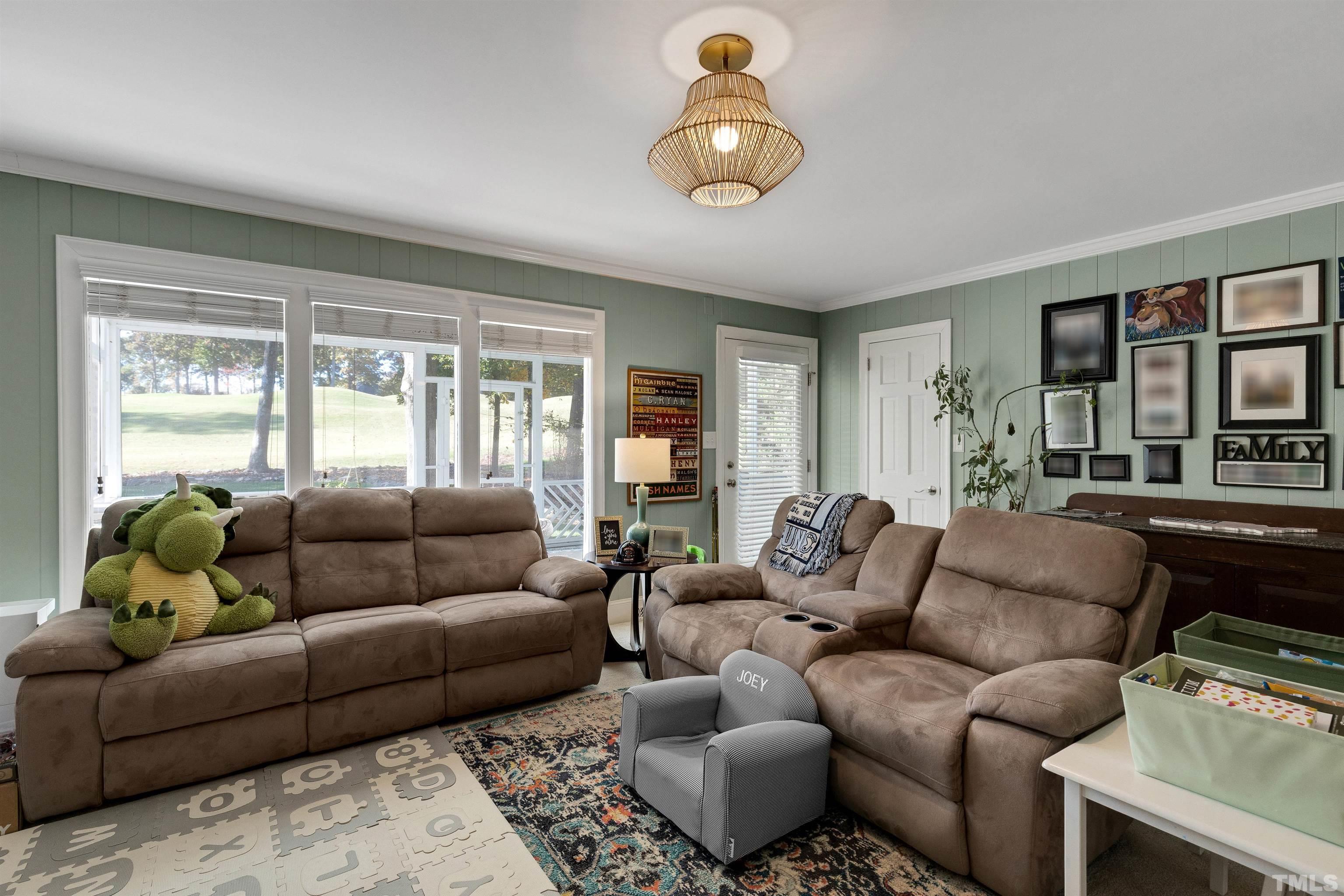 6813 Foxfire Place Raleigh, NC 27615 - Photo 28 of 38 a living room with furniture ceiling fan and a window