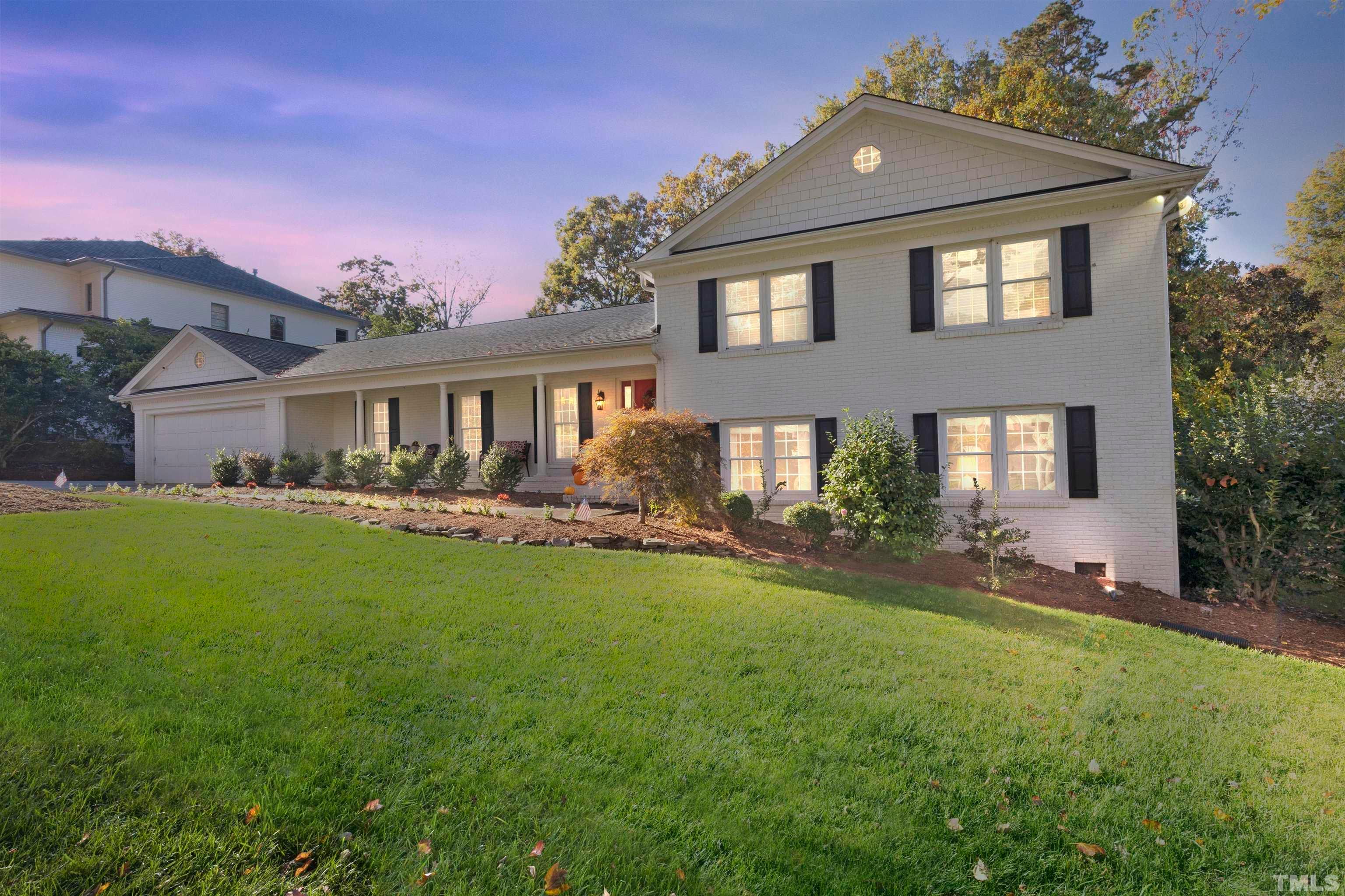 6813 Foxfire Place Raleigh, NC 27615 - Photo 4 of 38 a front view of a house with yard and green space