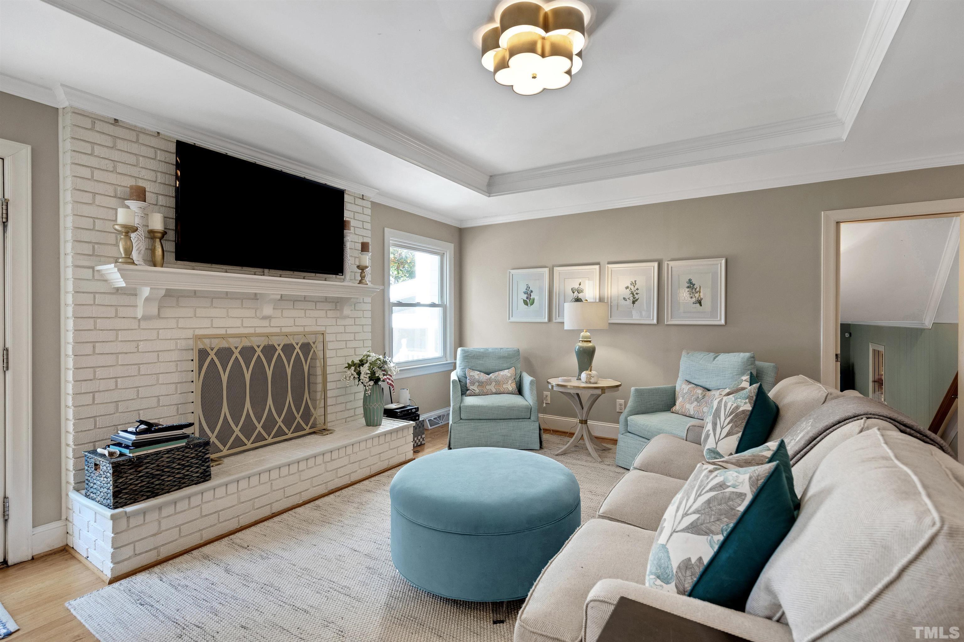 6813 Foxfire Place Raleigh, NC 27615 - Photo 9 of 38 a living room with furniture fireplace and a flat screen tv