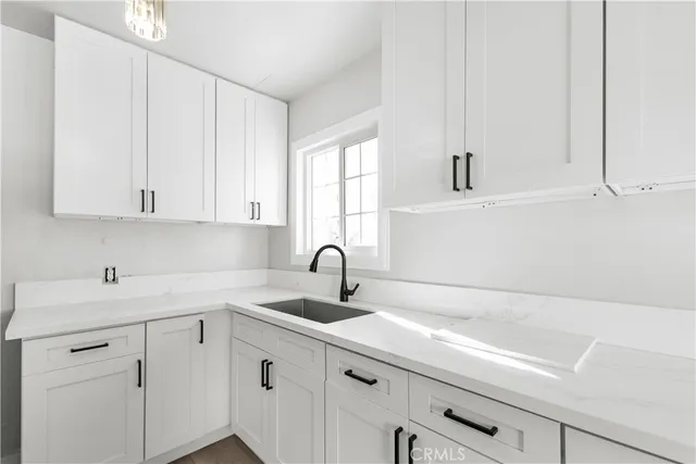 a kitchen with a stove a sink and a refrigerator