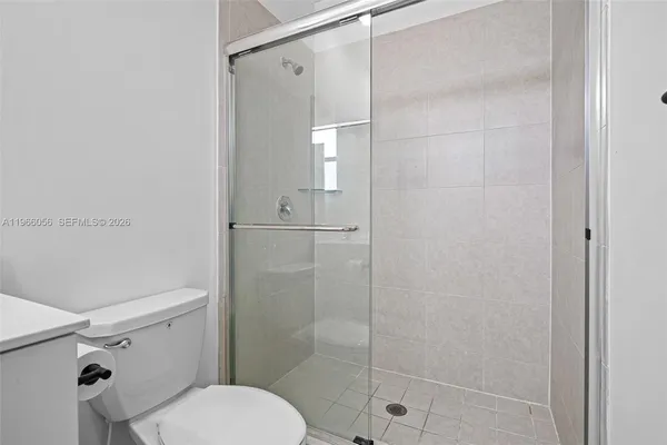 a bathroom with a granite countertop toilet a sink and a bathtub