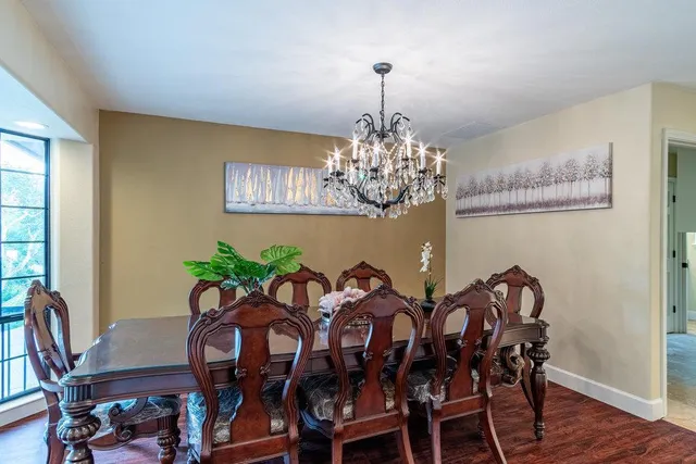 a kitchen with granite countertop a stove a sink and a wooden floors