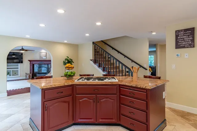 a living room with fireplace furniture and a potted plant