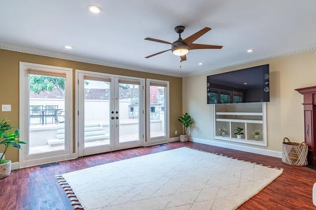 a living room with furniture and wooden floor
