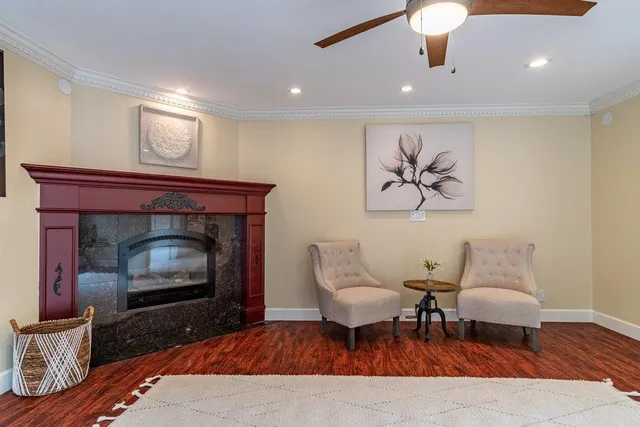 a spacious bedroom with a large bed and a chandelier fan