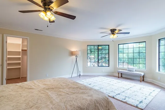 an empty room with chandelier and windows