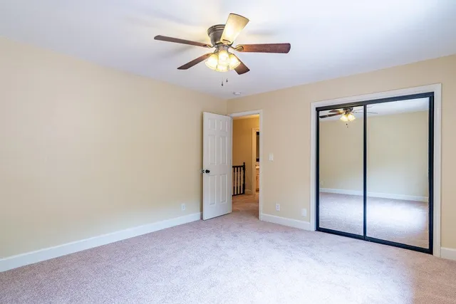 a front view of a house with a yard and trees