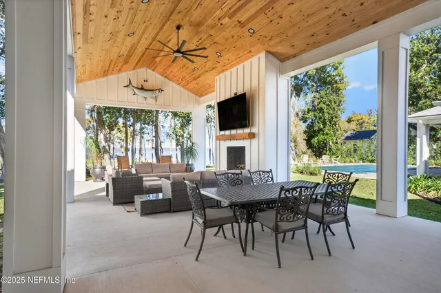 a kitchen with stainless steel appliances granite countertop a refrigerator a sink dishwasher a stove and white cabinets with wooden floor