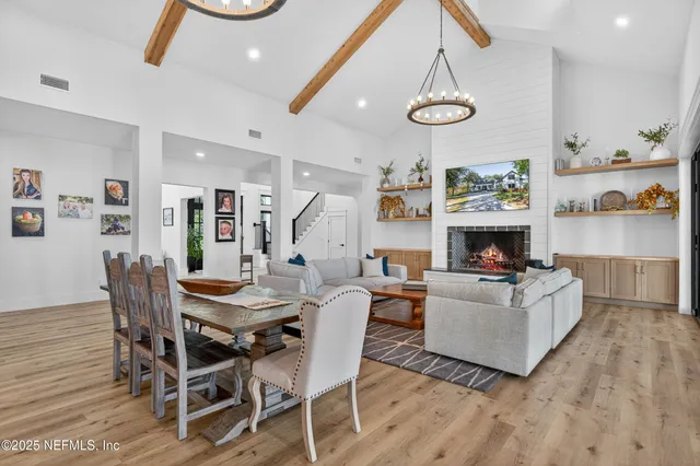 a spacious bedroom with a bed and a chandelier
