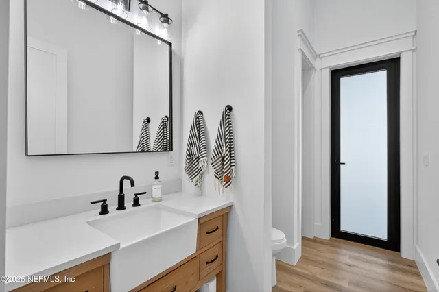 a view of a workspace with furniture and wooden floor