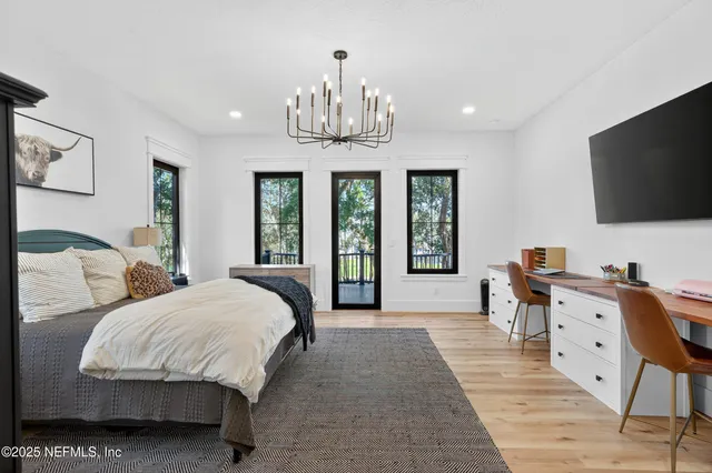 a living room with furniture a dining table and a chandelier