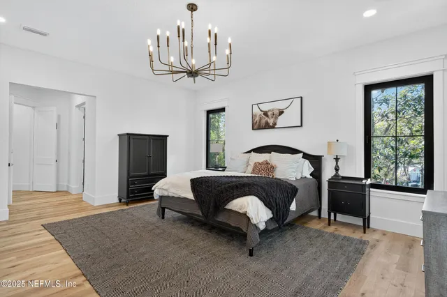 a living room with furniture kitchen view and large windows