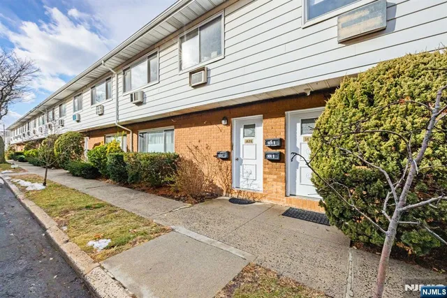 a view of a house with potted plants