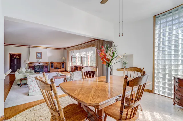 a view of a livingroom with wooden floor and a chandelier