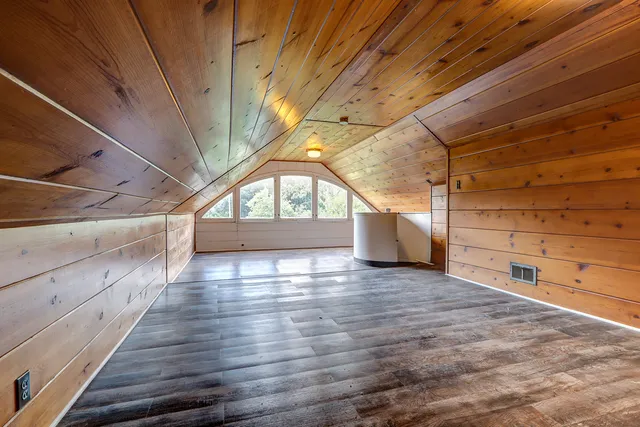 a view of a room with wooden walls