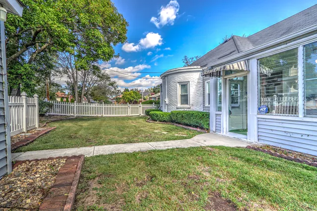an empty room with a fireplace and a chandelier